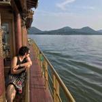 The author looks out at West Lake during a ferry ride in the city of Hangzhou.